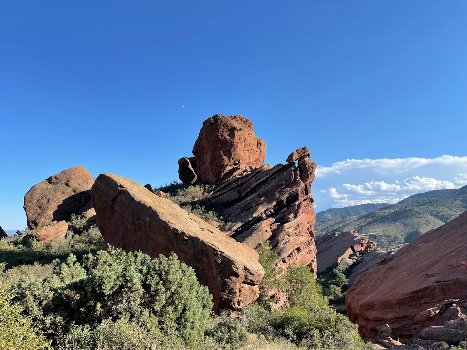 Daytime wide view of Red Rocks Amphitheatre rock formations and landscape